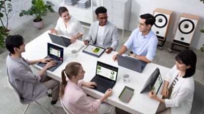 Happy colleagues work at computers in coworking office space, laugh discussing paperwork project, smiling diverse workers chat sharing ideas cooperating, employees involved in teambuilding activity; Shutterstock ID 1212177607; purchase_order: -; job: -; client: -; other: -